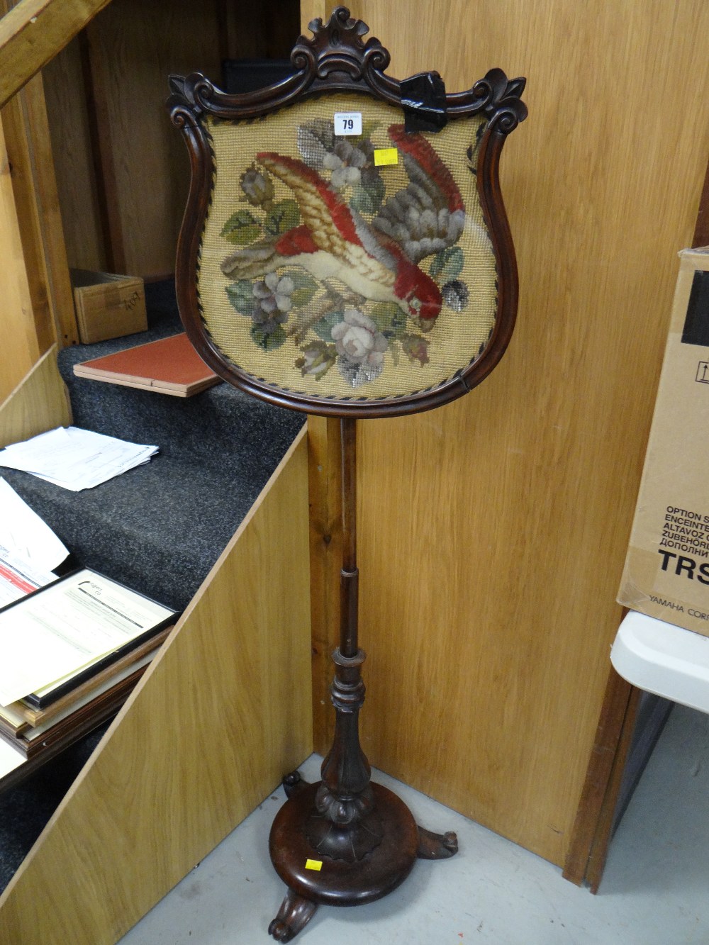 An adjustable antique rosewood pole screen with Berlin-work tapestry panel of parrot in flowers