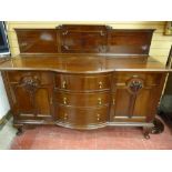 AN EARLY 20th CENTURY RAILBACK SIDEBOARD, the base section with three central bow front drawers