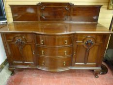 AN EARLY 20th CENTURY RAILBACK SIDEBOARD, the base section with three central bow front drawers