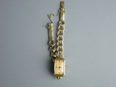 A FIFTEEN CARAT GOLD OBLONG DIAL ARCTOS ELITE WRISTWATCH, no. 25765 with an attractive link bracelet