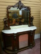 A VICTORIAN CARVED WALNUT MIRRORED CHIFFONIER with shaped marble top, the frame to the mirror with