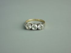 AN EIGHTEEN CARAT GOLD THREE STONE DIAMOND DRESS RING, visual estimate 0.3/0.45/0.3 carats, 2.7 grms