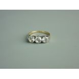 AN EIGHTEEN CARAT GOLD THREE STONE DIAMOND DRESS RING, visual estimate 0.3/0.45/0.3 carats, 2.7 grms