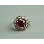 A NINE CARAT GOLD DRESS RING with centre pink stone and twelve small surrounding diamonds, 4.5 grms,