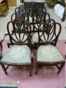 A SET OF SEVEN (SIX PLUS ONE) HEPPLEWHITE STYLE DINING CHAIRS, the pierced shield shaped backs