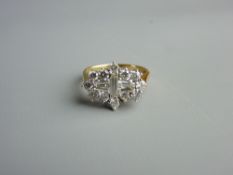 AN EIGHTEEN CARAT GOLD DIAMOND DRESS RING having a centre single baguette cut diamond with a