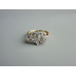 AN EIGHTEEN CARAT GOLD DIAMOND DRESS RING having a centre single baguette cut diamond with a