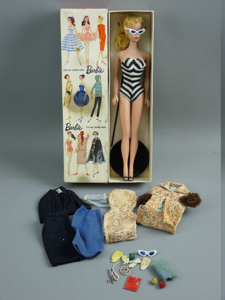 A VINTAGE BOXED BARBIE DOLL, dated 1959 with a quantity of clothing and accessories