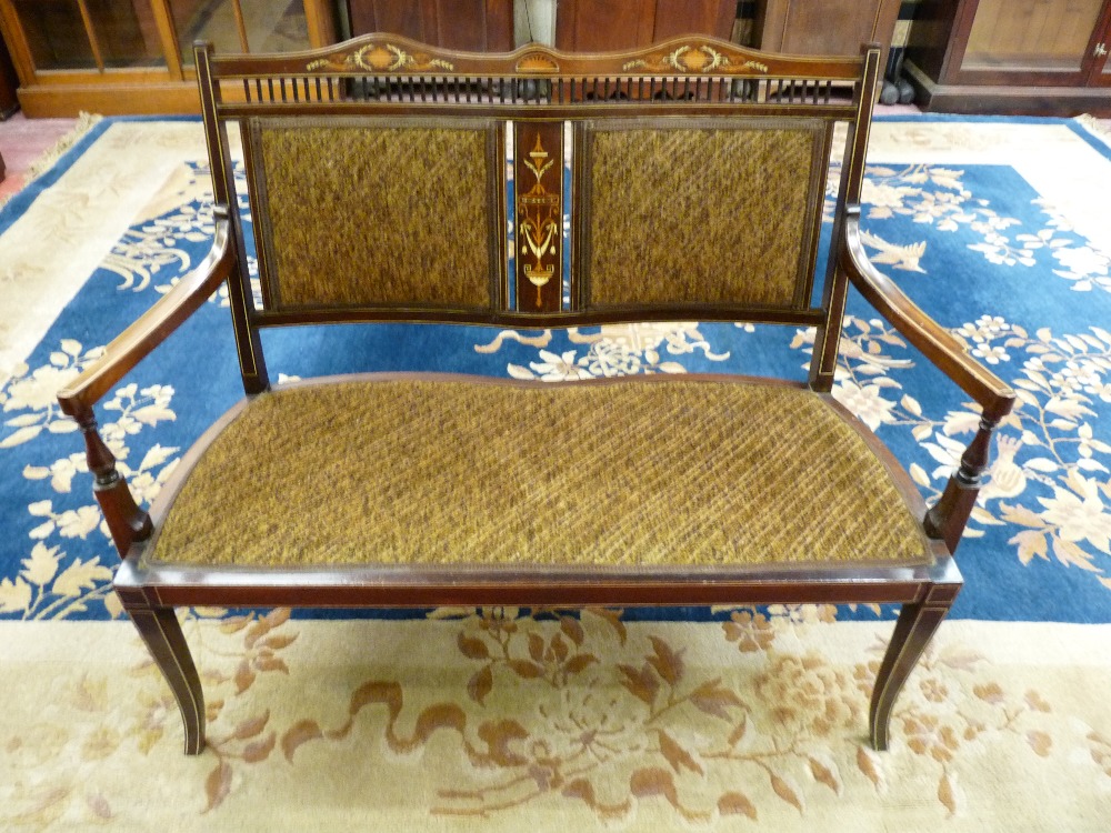 AN EDWARDIAN INLAID SALON SETTEE, the shaped top rail and central splat with ivory and satin wood