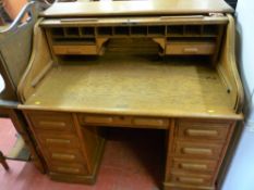 AN EARLY 20th CENTURY OAK ROLL TOP DESK, the tambour front opening to reveal an interior arrangement