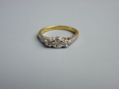 AN EIGHTEEN CARAT GOLD DRESS RING with three small diamonds, 3 grms gross