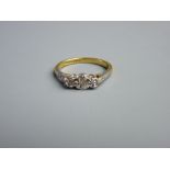 AN EIGHTEEN CARAT GOLD DRESS RING with three small diamonds, 3 grms gross