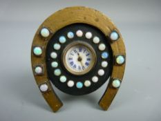 A MINIATURE BEDSIDE CLOCK set with twenty five opals, the enamel dial set with Roman numerals in