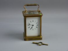A HEAVY BRASS CARRIAGE CLOCK, late 19th/early 20th Century, white dial with Roman numerals, triple