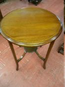 AN EDWARDIAN MAHOGANY TWO TIER CIRCULAR TABLE with boxwood stringing, 73 cms high, 56 cms diameter