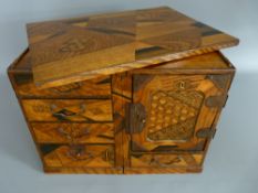 A JAPANESE MARQUETRY TABLE CABINET converting to a miniature kneehole desk, typical Yosegi-Zaiku