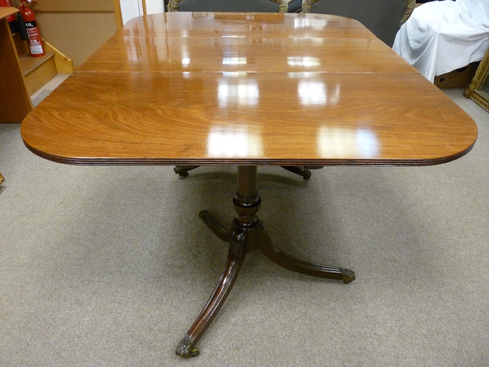 A GOOD GEORGIAN MAHOGANY TWIN PEDESTAL TILT TOP DINING TABLE with one extra leaf, the table ends