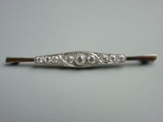 AN EIGHTEEN CARAT PLATINUM OBLONG BAR BROOCH, the shaped bar having a centre round cut diamond,