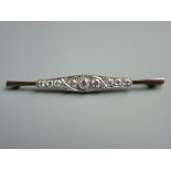 AN EIGHTEEN CARAT PLATINUM OBLONG BAR BROOCH, the shaped bar having a centre round cut diamond,