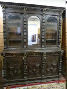 A LARGE FLEMISH STYLE THREE DOOR BOOKCASE CUPBOARD, the inverted crown over a gadrooned frieze