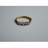 A TWENTY TWO CARAT GOLD WEDDING RING of five small diamonds, visual estimate 0.7 carat, 3.9 grms