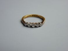 A TWENTY TWO CARAT GOLD WEDDING RING of five small diamonds, visual estimate 0.7 carat, 3.9 grms