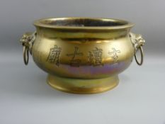 A LARGE CHINESE POLISHED BRONZE CENSER weighing 13 kgs, with lion mask and ring handles on a Bombe