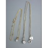 TWO CZ PENDANTS, one on a silver link chain, total 1.2 grms and a cz pendant on a silver link chain,