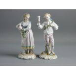 A PAIR OF GERMAN PORCELAIN FIGURES in 18th Century style dress of a young standing man with a