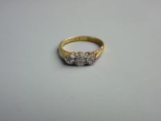 AN EIGHTEEN CARAT GOLD DRESS RING of three small diamonds, 2.8 grms gross