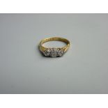 AN EIGHTEEN CARAT GOLD DRESS RING of three small diamonds, 2.8 grms gross