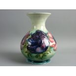 A MOORCROFT ANEMONE BULBOUS VASE decorated on a muted green ground, impressed and painted 'W M'