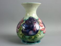 A MOORCROFT ANEMONE BULBOUS VASE decorated on a muted green ground, impressed and painted 'W M'