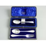 A CASED HALLMARKED SILVER NAPKIN RING & SPOON SET and a cased fork and spoon set, Sheffield 1897 and