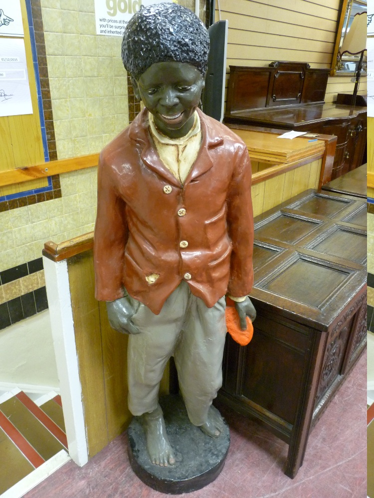 A 20th CENTURY COMPOSITION MODEL OF A LIFE SIZE STANDING PAPIER MACHE BLACK BOY on a circular
