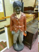 A 20th CENTURY COMPOSITION MODEL OF A LIFE SIZE STANDING PAPIER MACHE BLACK BOY on a circular