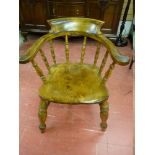 A VINTAGE SMOKER'S BOW ARMCHAIR with spindle turned arm and base supports with 'H' cross