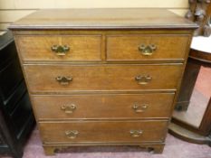 A 19th CENTURY OAK CHEST of two short over three long drawers, with cockbeaded edging, shaped brass