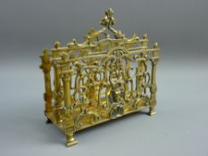 AN ORNATE BRASS ANTIQUE LETTER STAND with Corinthian capped pillar ends, the pierced front and