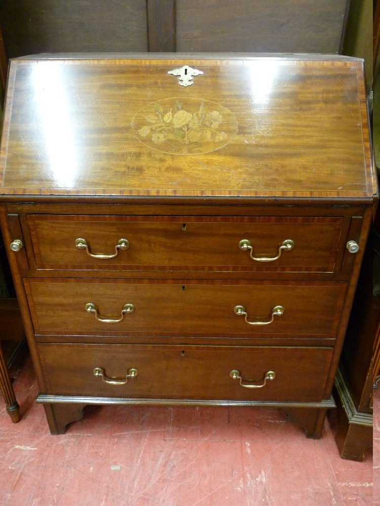 AN EDWARDIAN INLAID MAHOGANY FALL FRONT BUREAU with crossbanded edges and floral inlaid front