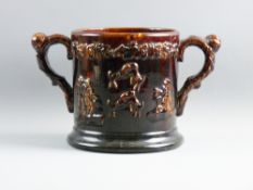 A LARGE ROCKINGHAM TYPE TREACLE GLAZED LOVING CUP with coiled snake to the interior (head absent),