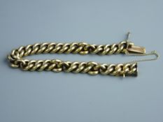 A HEAVY GOLD LINK BRACELET & SAFETY CHAIN, 66.5 grms