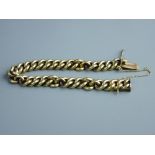 A HEAVY GOLD LINK BRACELET & SAFETY CHAIN, 66.5 grms