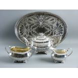 A CLOSELY MATCHED GEORGIAN SILVER TEA SERVICE with gadrooned bodies, the teapot hallmarked London