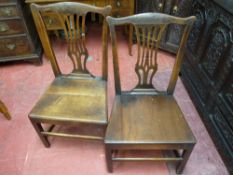 A MATCHING PAIR OF ANTIQUE OAK FARMHOUSE CHAIRS with pierced backsplat