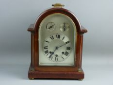 A MAHOGANY THREE TRAIN BRACKET CLOCK, the arched silvered dial set with Roman numerals, with slow/