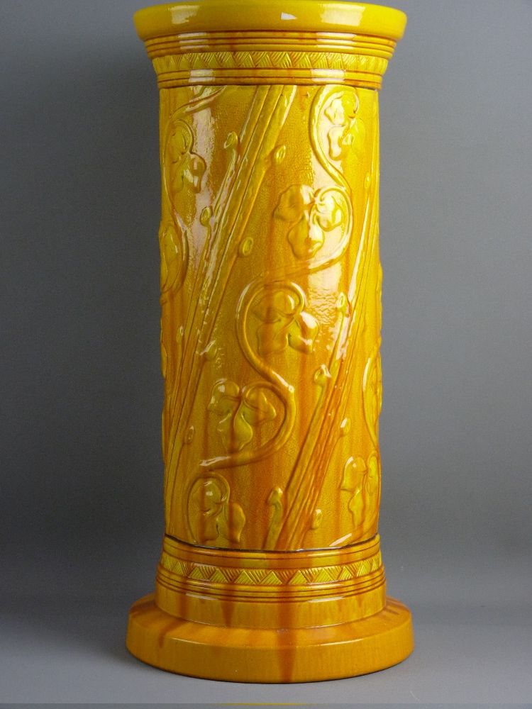 A BURMANTOFTS YELLOW GLAZED JARDINIERE PEDESTAL of cylindrical form with raised flowers to a wide