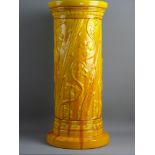 A BURMANTOFTS YELLOW GLAZED JARDINIERE PEDESTAL of cylindrical form with raised flowers to a wide