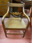 AN ANTIQUE OAK FARMHOUSE ARMCHAIR with shaped centre rail, 52 cms wide