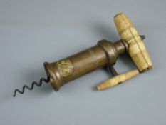 A VICTORIAN DOWLER PATENT BRASS CORKSCREW with turned bone grip and ratchet side handle, 20 cms long